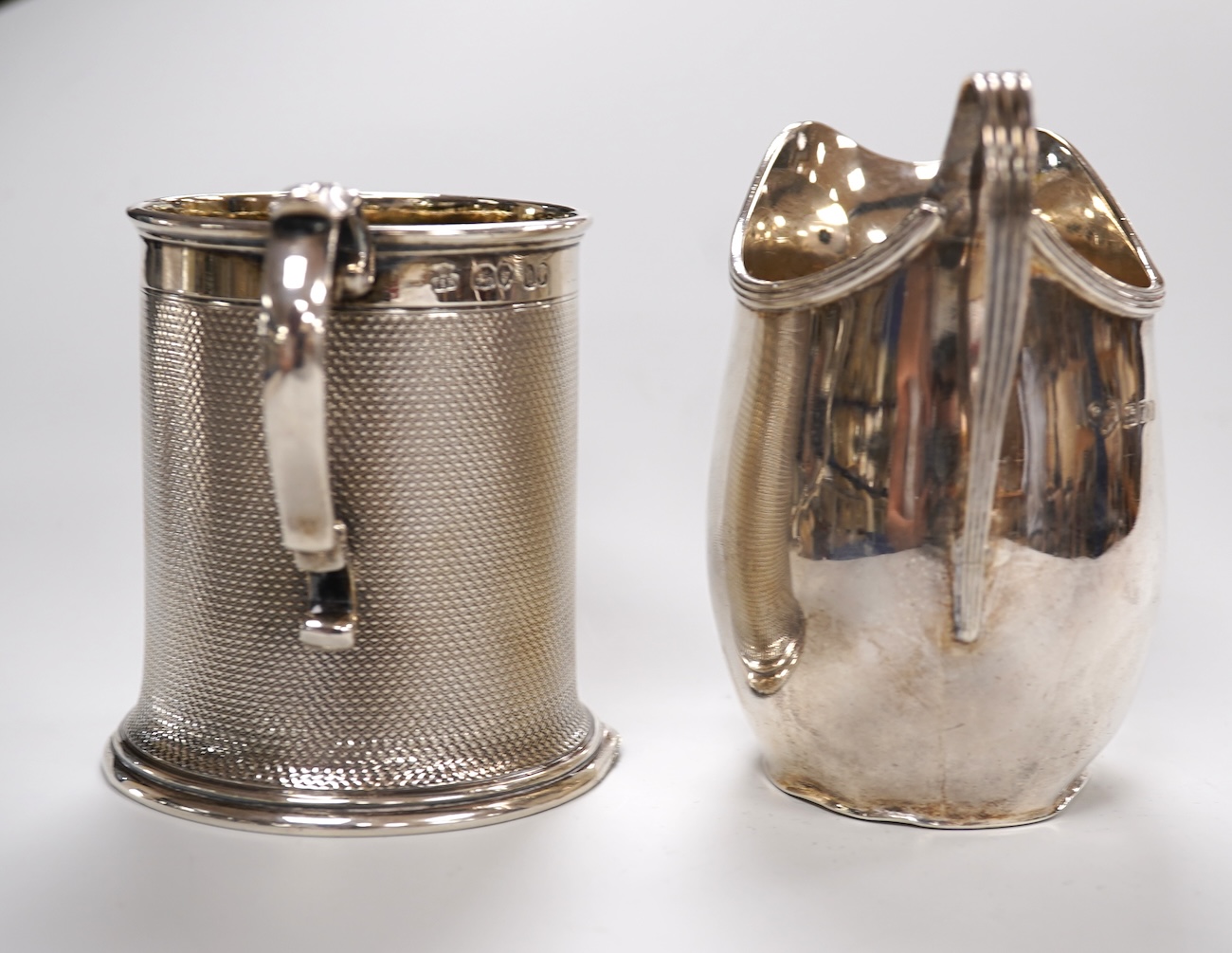 A Victorian engine turned silver christening mug by John Samuel Hunt (Hunt & Roskell), London, 1863, with later engraved inscription to the base, height 89mm, together with a George VI silver cream jug, London, 1947, 12o